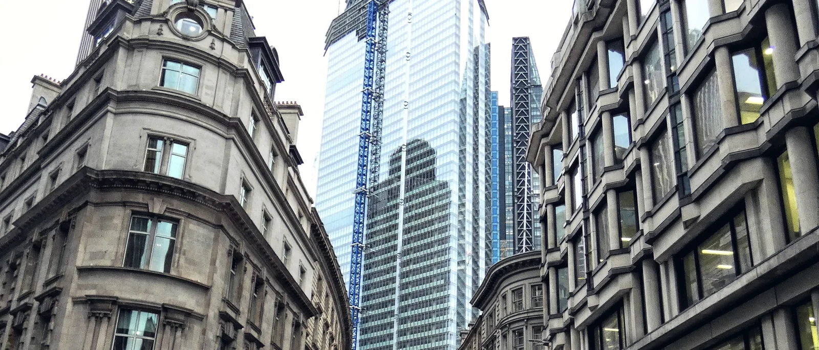 22 Bishopsgate under construction rising behind the stone facades of Threadneedle Street