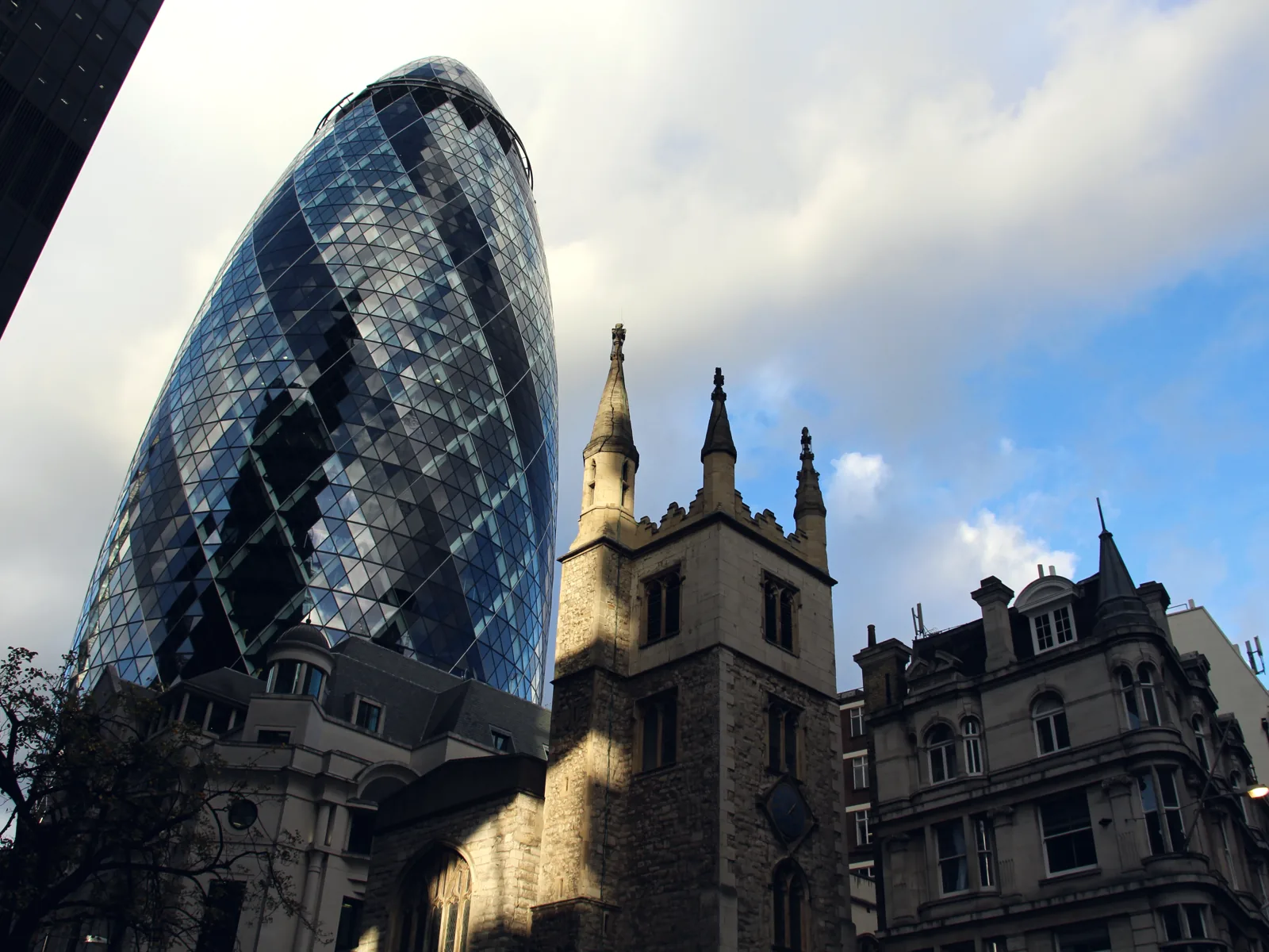 The Gherkin rising behind the medieval church of St Andrew Undershaft